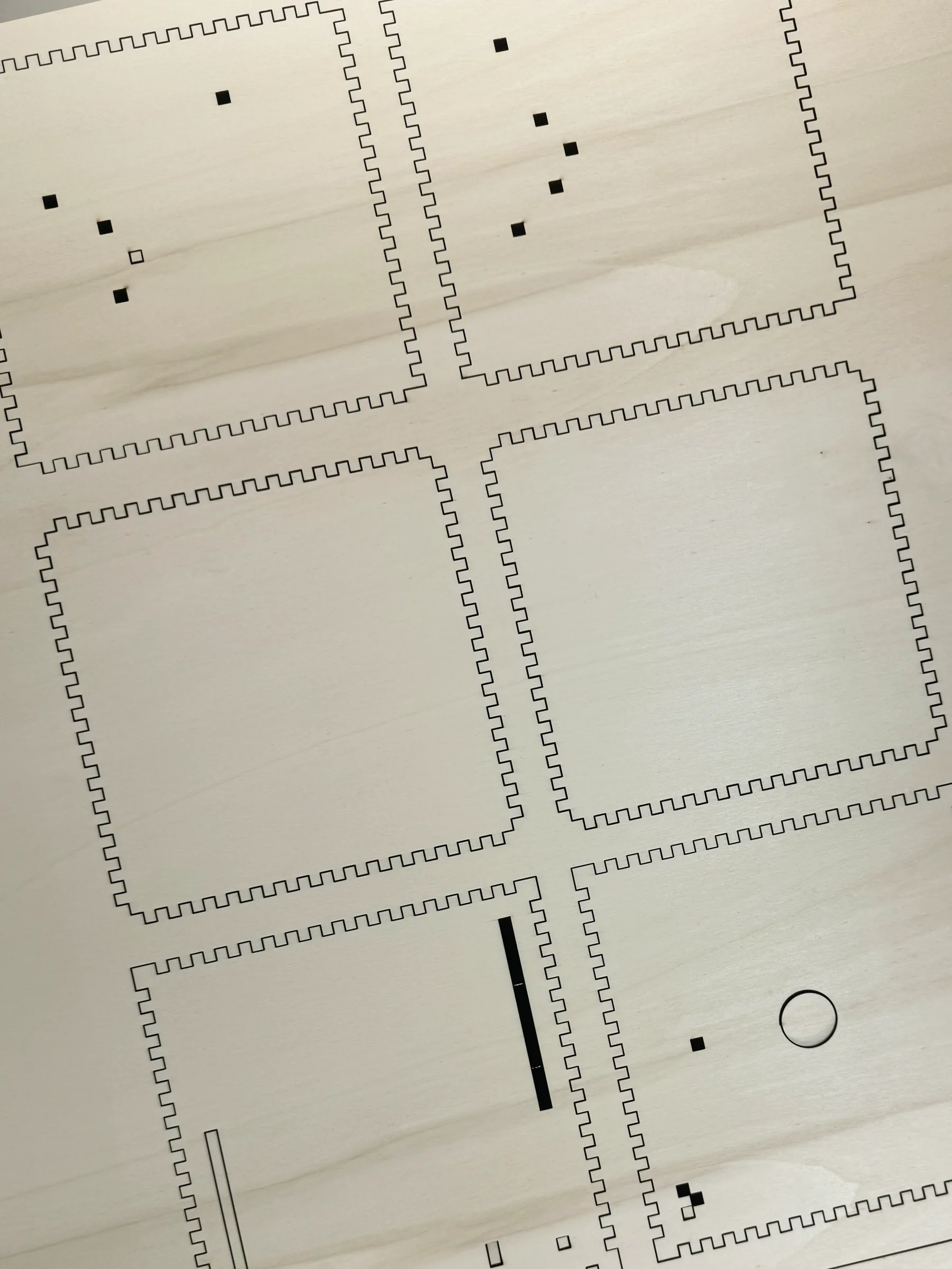All the laser-cut parts of the box on a sheet of birch plywood